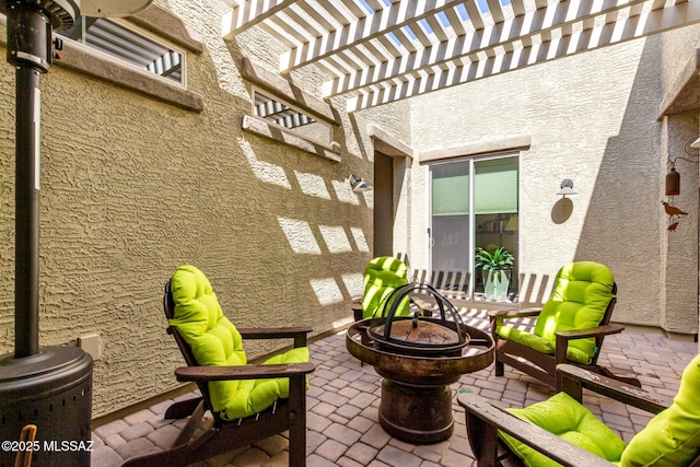 view of patio / terrace featuring a fire pit and a pergola