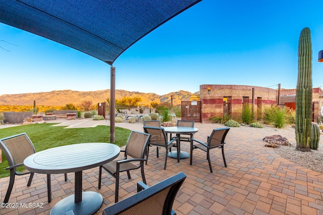 view of patio / terrace featuring a mountain view and fence