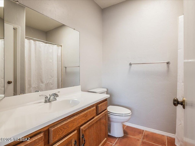 full bathroom with tile patterned floors, toilet, vanity, and baseboards