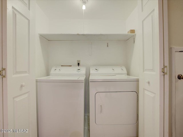 clothes washing area featuring washer and dryer and laundry area