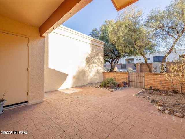 view of patio with fence and a gate