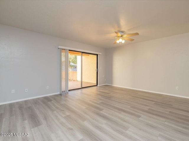 unfurnished room with a ceiling fan, light wood-style floors, and baseboards