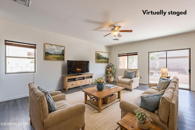 living area featuring ceiling fan, wood finished floors, visible vents, and baseboards