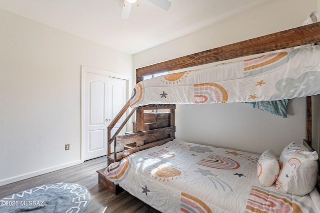 bedroom with wood finished floors, baseboards, a closet, and ceiling fan