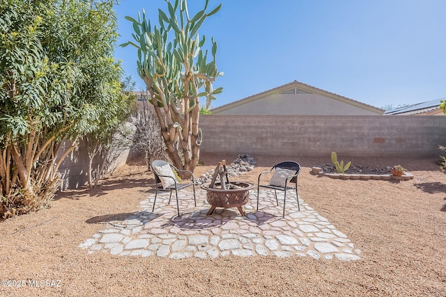 view of yard featuring an outdoor fire pit, a fenced backyard, and a patio area