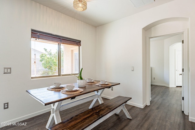 dining room with visible vents, arched walkways, baseboards, and dark wood finished floors