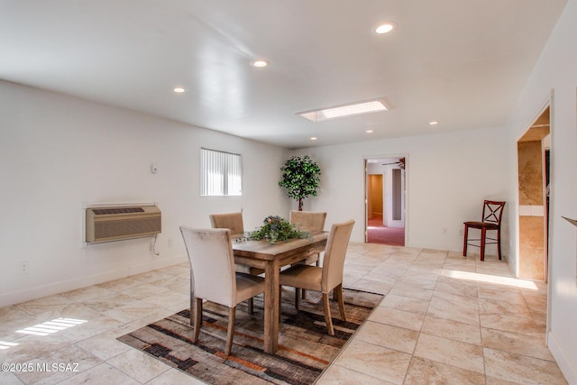 dining space with a skylight, recessed lighting, and baseboards