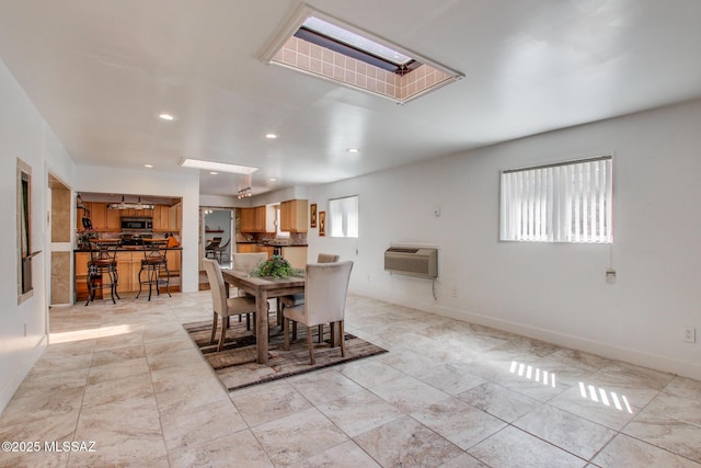 dining area featuring recessed lighting, baseboards, and a wall unit AC