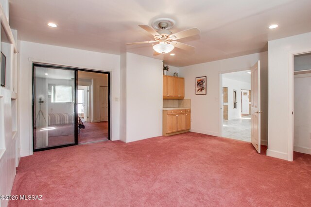 interior space featuring recessed lighting, light colored carpet, and ceiling fan