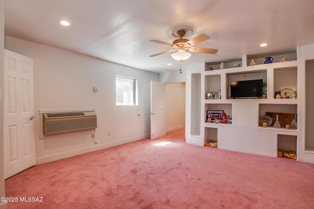 interior space featuring a wall unit AC, carpet flooring, a ceiling fan, and recessed lighting