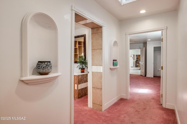 corridor featuring light carpet, recessed lighting, and baseboards