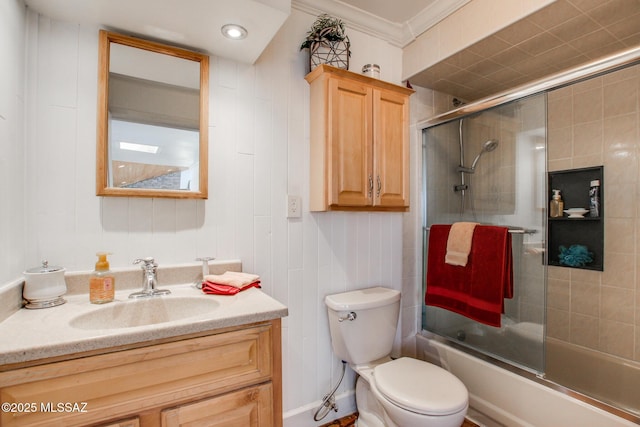 full bath with shower / bath combination with glass door, toilet, vanity, and crown molding