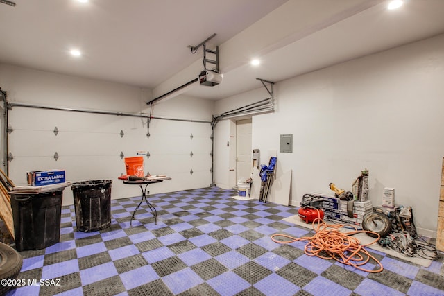 garage with electric panel, a garage door opener, and recessed lighting