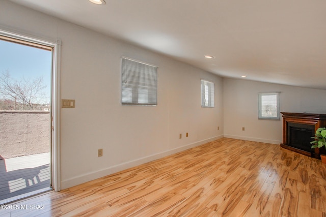 unfurnished living room featuring recessed lighting, light wood-type flooring, baseboards, and a fireplace