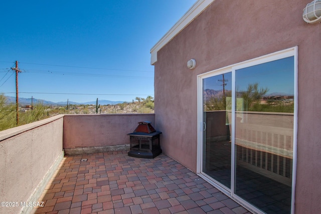 view of patio / terrace with a balcony and a mountain view