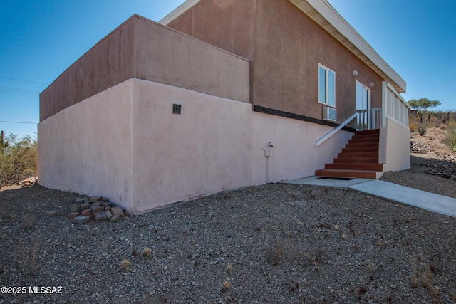 view of side of home with stucco siding