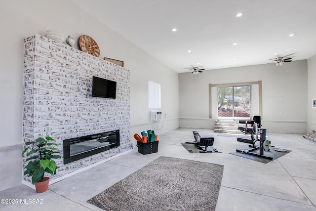 workout area featuring recessed lighting, a brick fireplace, a wall mounted air conditioner, and ceiling fan