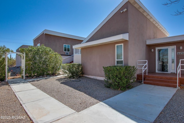 view of side of home with stucco siding