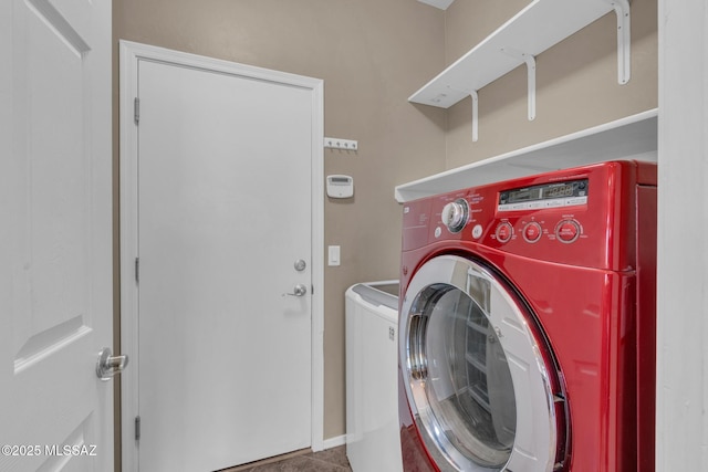 washroom featuring washing machine and clothes dryer and laundry area