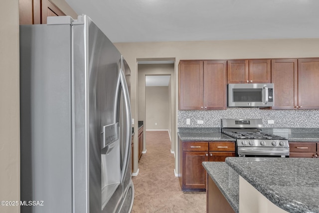 kitchen featuring tasteful backsplash, appliances with stainless steel finishes, and brown cabinetry