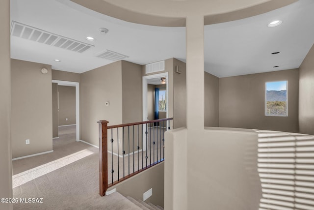 hallway with recessed lighting, carpet flooring, an upstairs landing, and visible vents