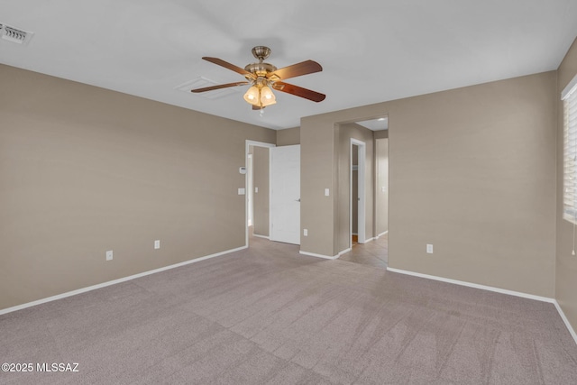 spare room featuring visible vents, baseboards, carpet, and ceiling fan