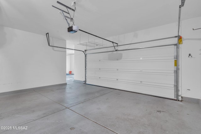 garage with a garage door opener and baseboards