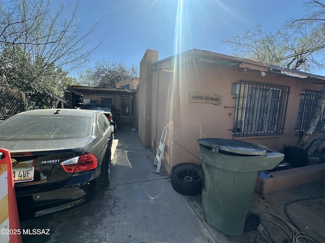 view of home's exterior featuring a carport