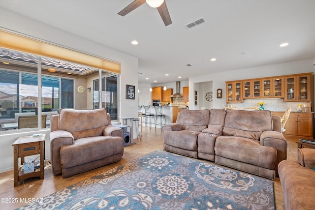 living room with a ceiling fan, light tile patterned floors, recessed lighting, and visible vents