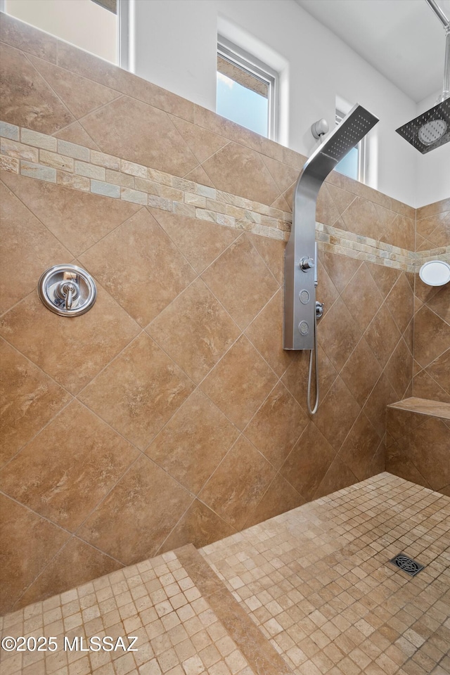 bathroom with a tile shower