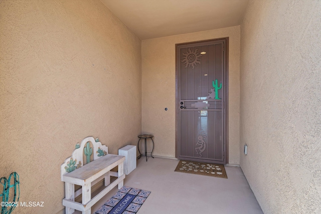 entrance to property with stucco siding