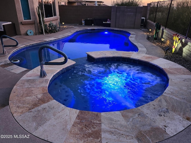 7006 W Cape Final Trl, Marana, AZ 85658 - pool at dusk featuring a fenced backyard and a pool with connected hot tub