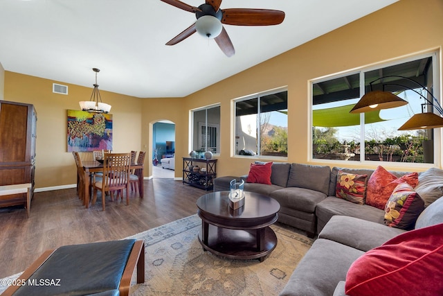 499 W Windowmaker Rd, Tucson, AZ 85737 - living room featuring ceiling fan with notable chandelier, arched walkways, visible vents, wood finished floors, and lofted ceiling
