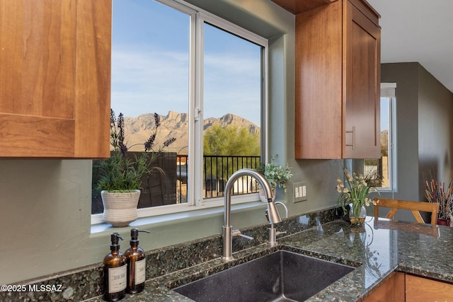 499 W Windowmaker Rd, Tucson, AZ 85737 - kitchen featuring a sink, a mountain view, dark stone countertops, and brown cabinets