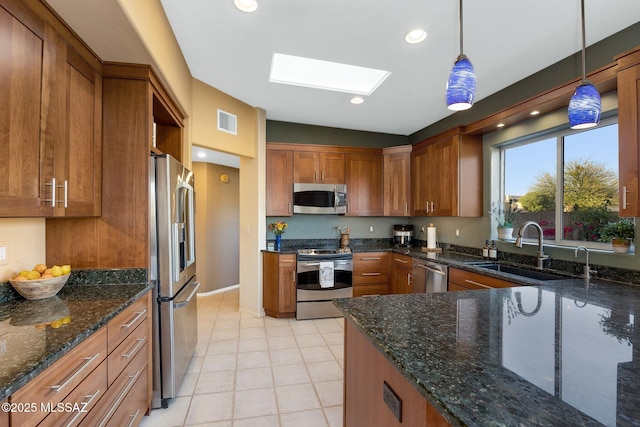 499 W Windowmaker Rd, Tucson, AZ 85737 - kitchen with visible vents, brown cabinets, a sink, and appliances with stainless steel finishes