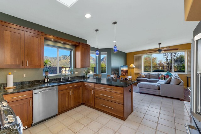 499 W Windowmaker Rd, Tucson, AZ 85737 - kitchen with brown cabinetry, a peninsula, appliances with stainless steel finishes, a sink, and open floor plan