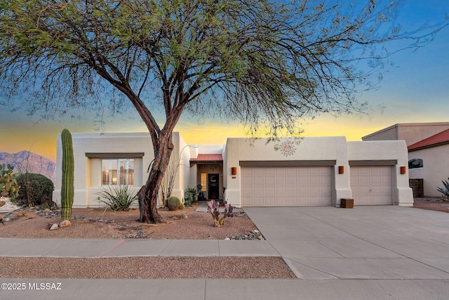 499 W Windowmaker Rd, Tucson, AZ 85737 - pueblo-style house with an attached garage, stucco siding, and concrete driveway