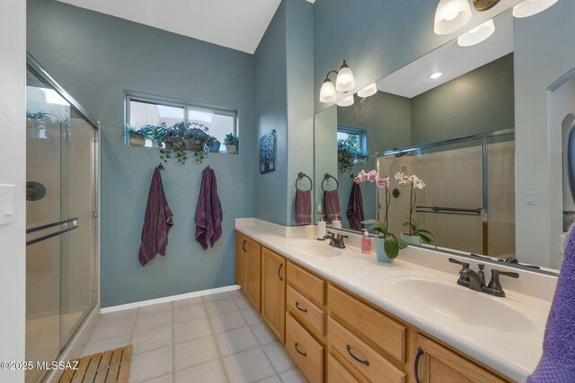 499 W Windowmaker Rd, Tucson, AZ 85737 - full bath with a stall shower, double vanity, a sink, and baseboards