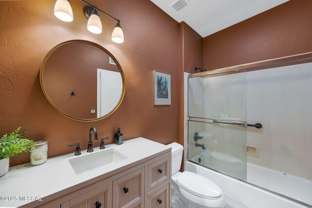 499 W Windowmaker Rd, Tucson, AZ 85737 - full bathroom featuring visible vents, combined bath / shower with glass door, toilet, a textured wall, and vanity