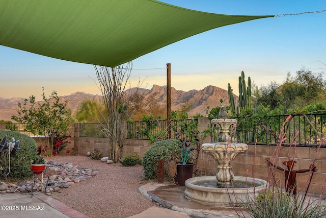 499 W Windowmaker Rd, Tucson, AZ 85737 - patio terrace at dusk with a mountain view and fence