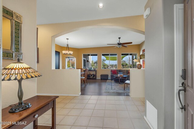 499 W Windowmaker Rd, Tucson, AZ 85737 - tiled foyer entrance with arched walkways, ceiling fan, baseboards, and visible vents