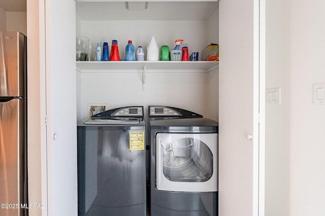 washroom featuring laundry area and washer and clothes dryer