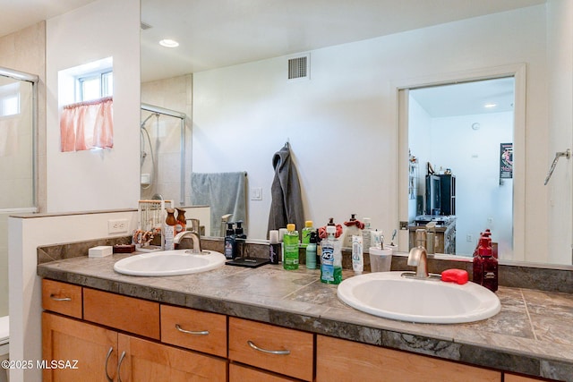 bathroom featuring a sink, visible vents, double vanity, and a shower stall