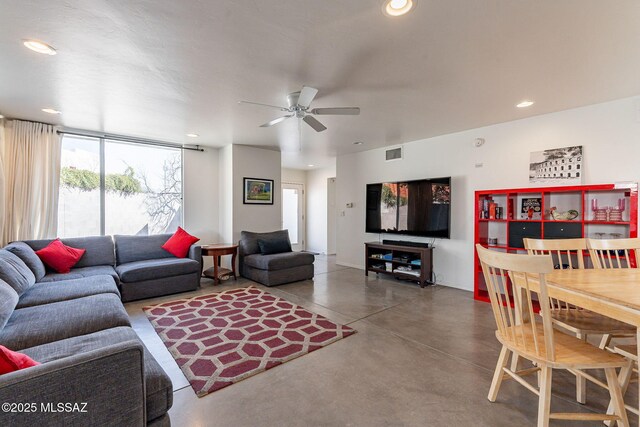 living area with recessed lighting, visible vents, finished concrete flooring, and a ceiling fan