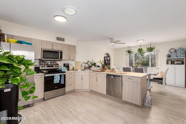 kitchen featuring visible vents, appliances with stainless steel finishes, light countertops, and a ceiling fan