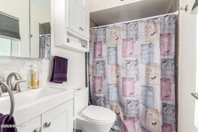 bathroom with a shower with curtain, tasteful backsplash, vanity, and toilet