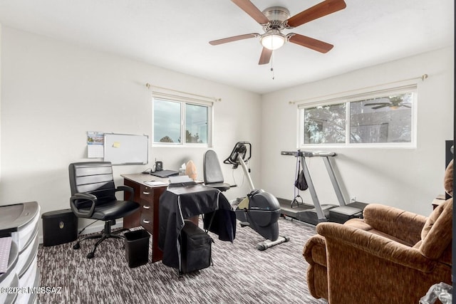 carpeted home office featuring a ceiling fan