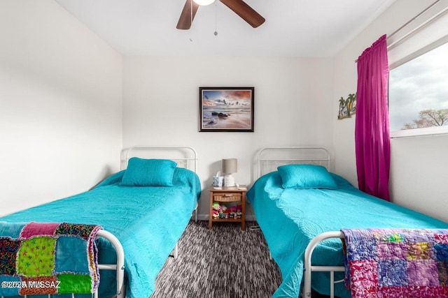 bedroom featuring a ceiling fan and carpet