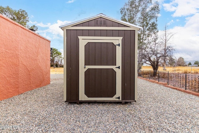 view of shed with fence