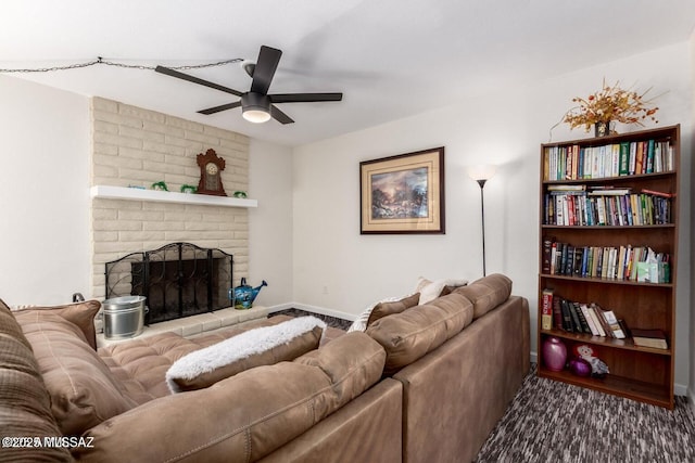 living area featuring a fireplace, baseboards, and ceiling fan